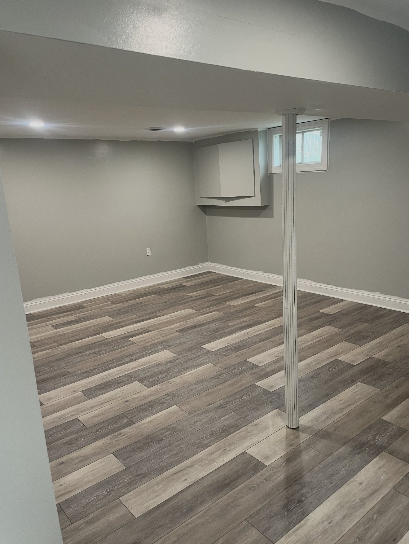 Grey luxury vinyl plank floor in a freshly finished basement